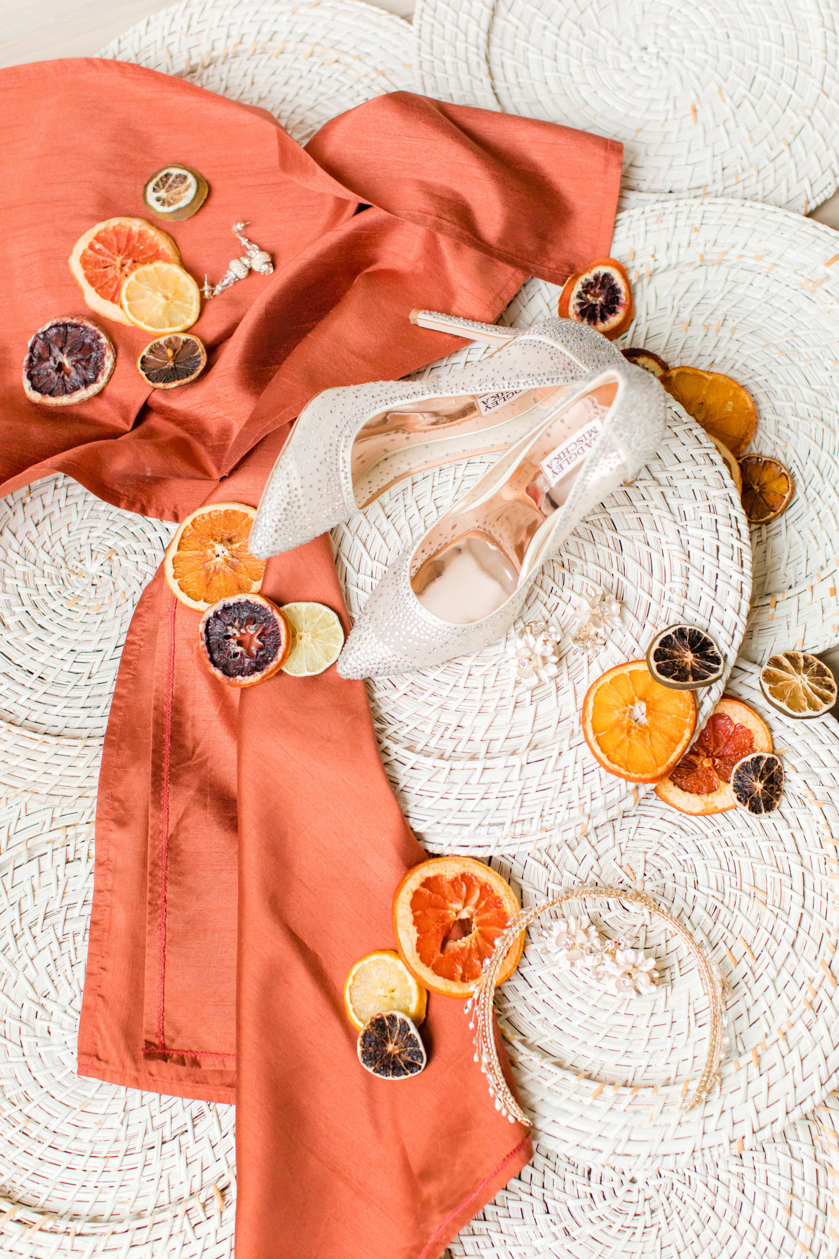 bride's details with coral sash and citrus slices for Ironworks at Pencoyd Landing wedding editorial