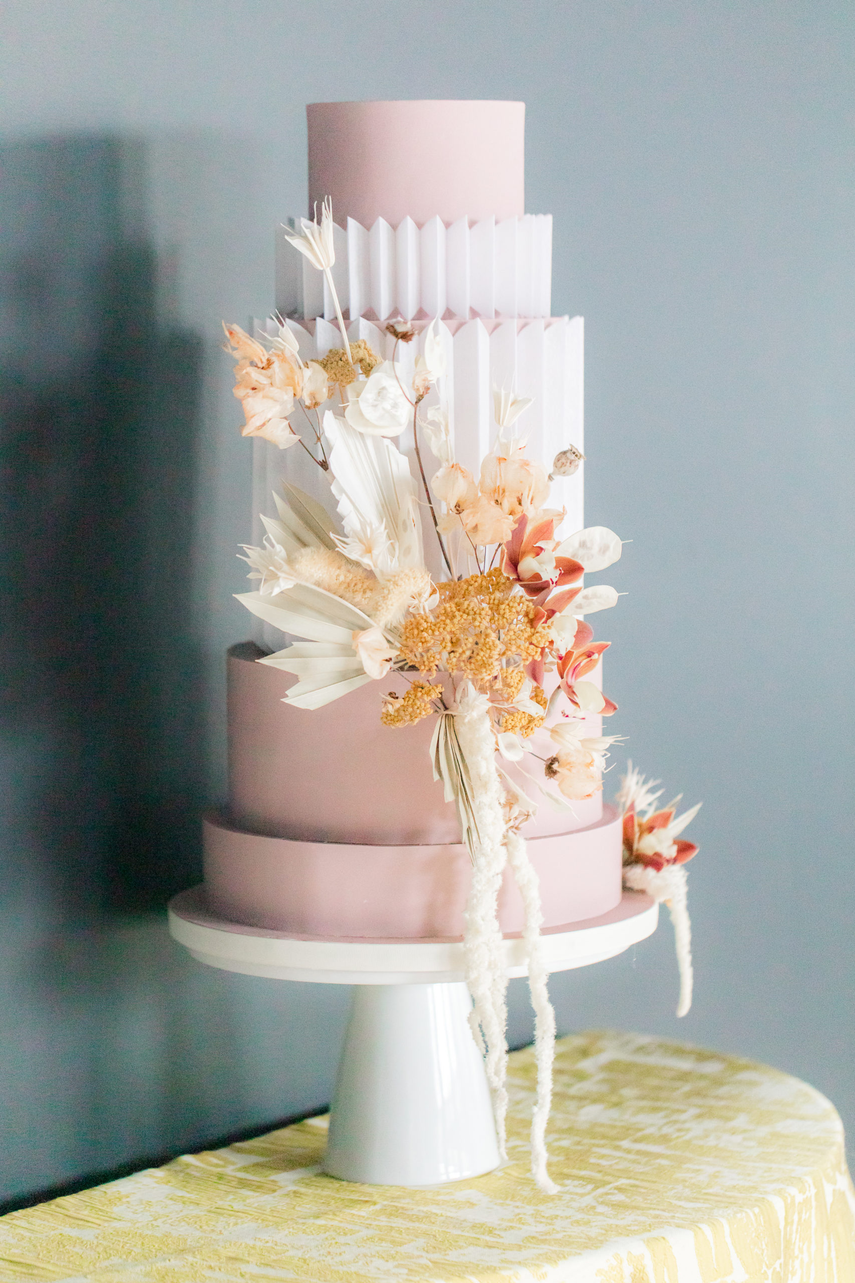 modern wedding cake with pink and white geometric layers 