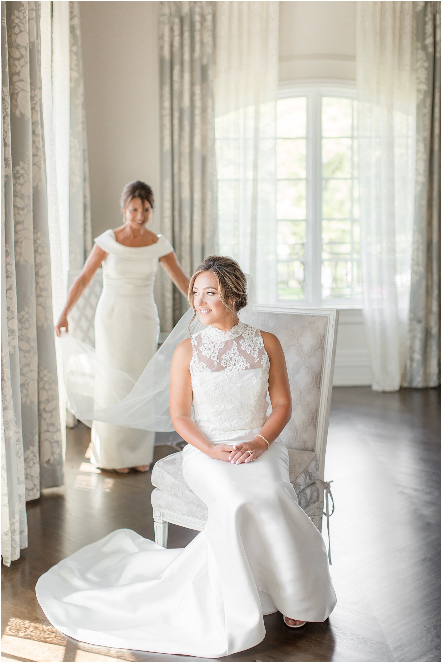 mom helps with veil for wedding morning prep