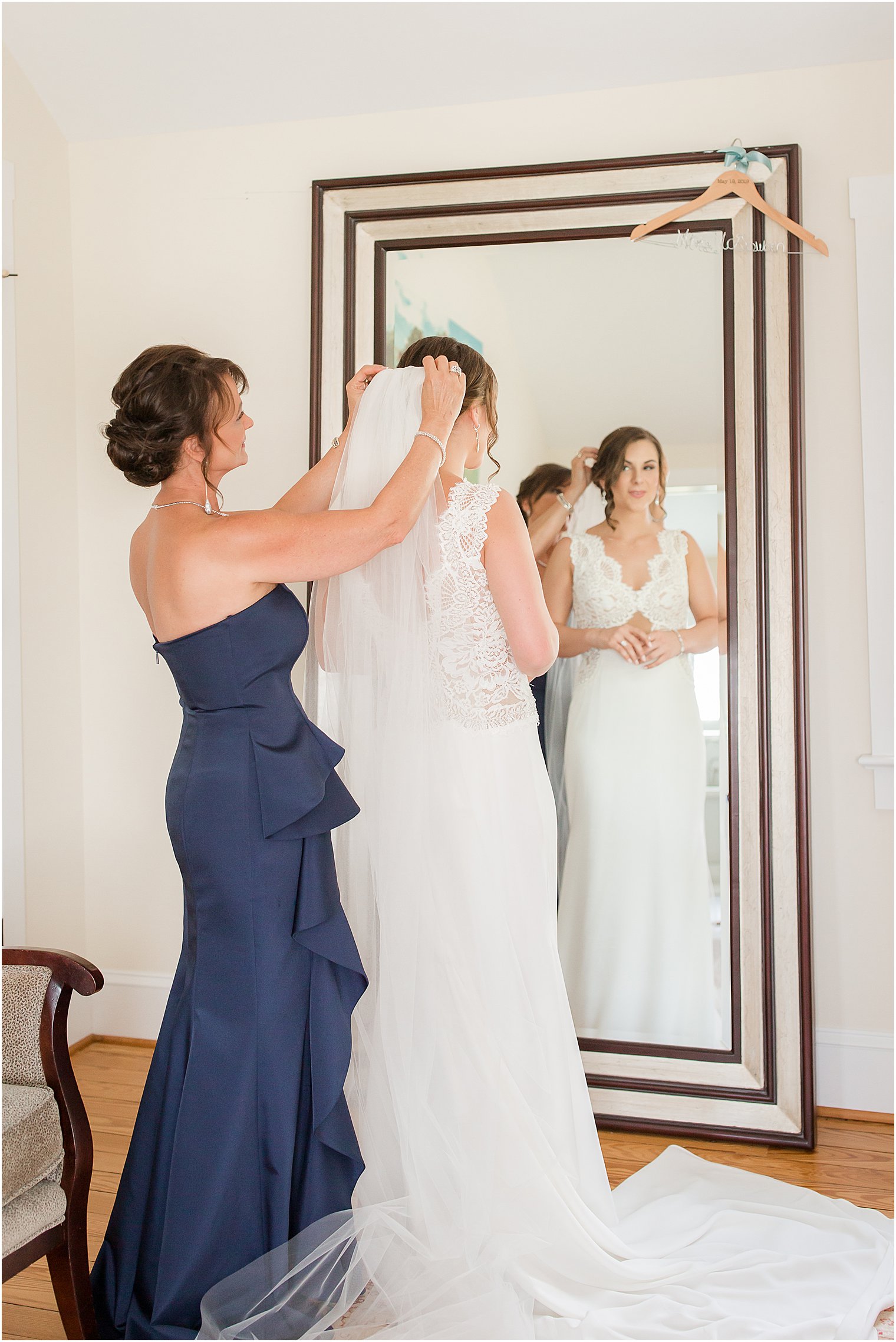 mother prepares daughter for wedding day