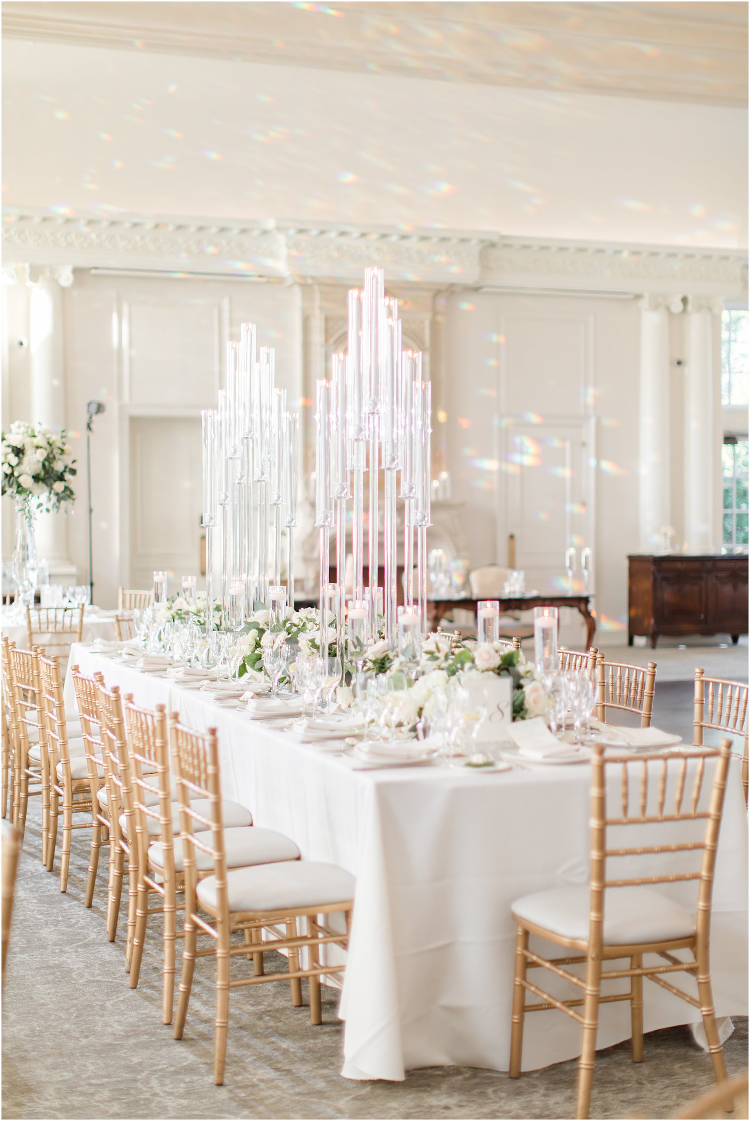 wedding reception with gold chivari chairs and ivory details 