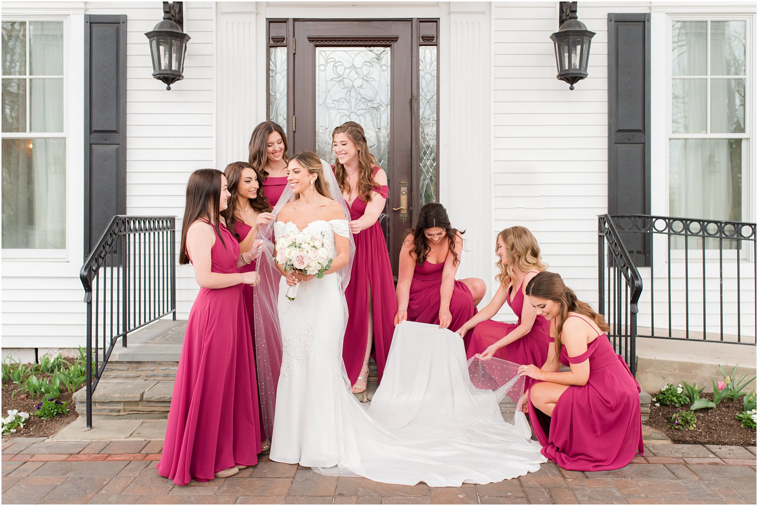 bridesmaids in fuchsia dresses help bride get ready for Park Savoy Estate wedding