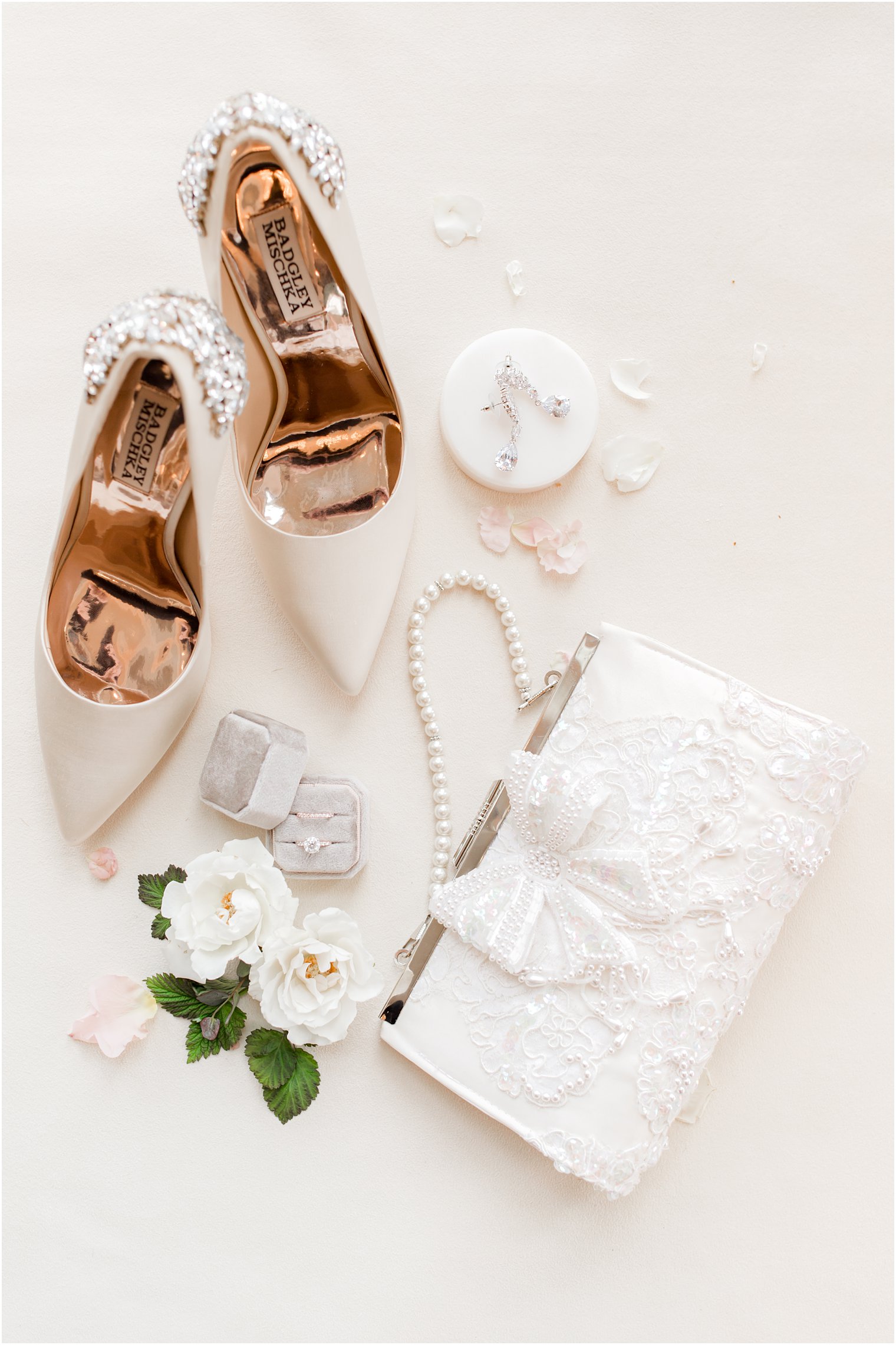 bride's ivory clutch and wedding rings in grey box before spring wedding 