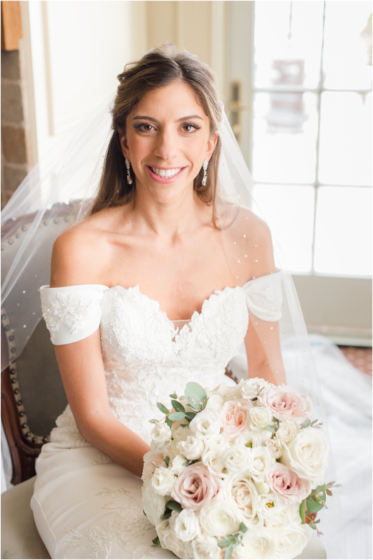 classic bride with veil holds ivory and pink bouquet in New Jersey 
