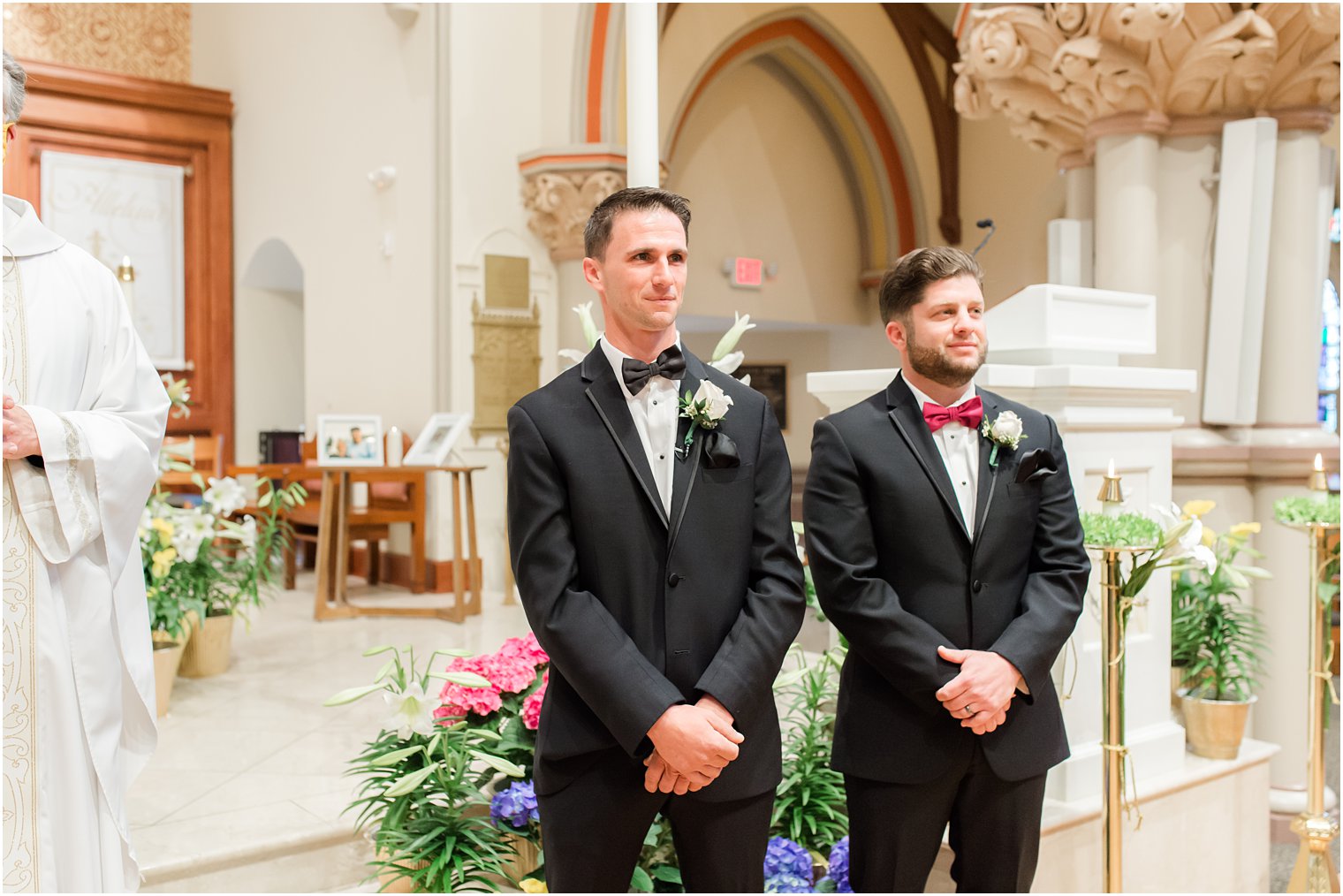 groom watches bride enter traditional Catholic Church wedding in New Jersey