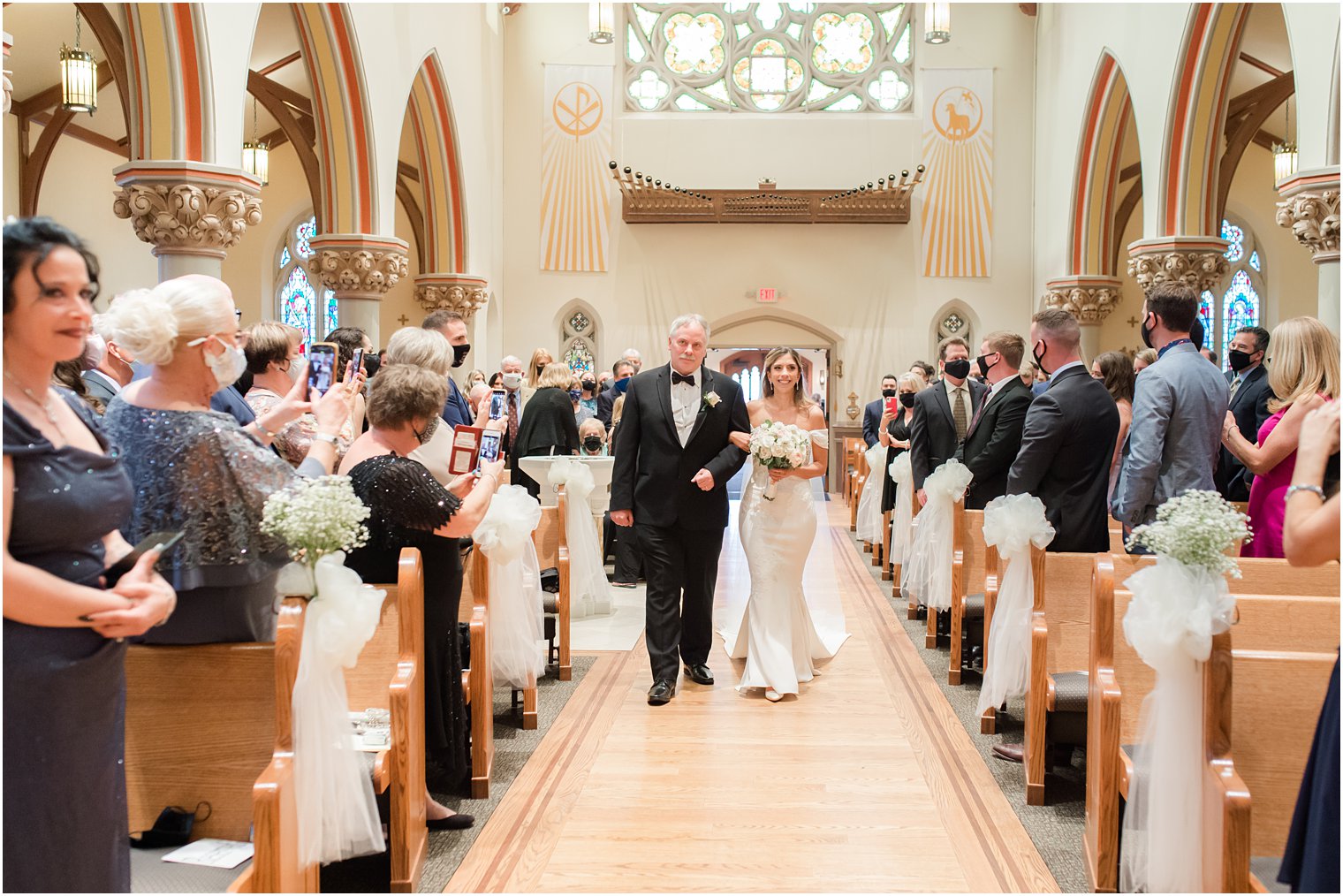 bride enters wedding ceremony during traditional Catholic Church wedding in New Jersey