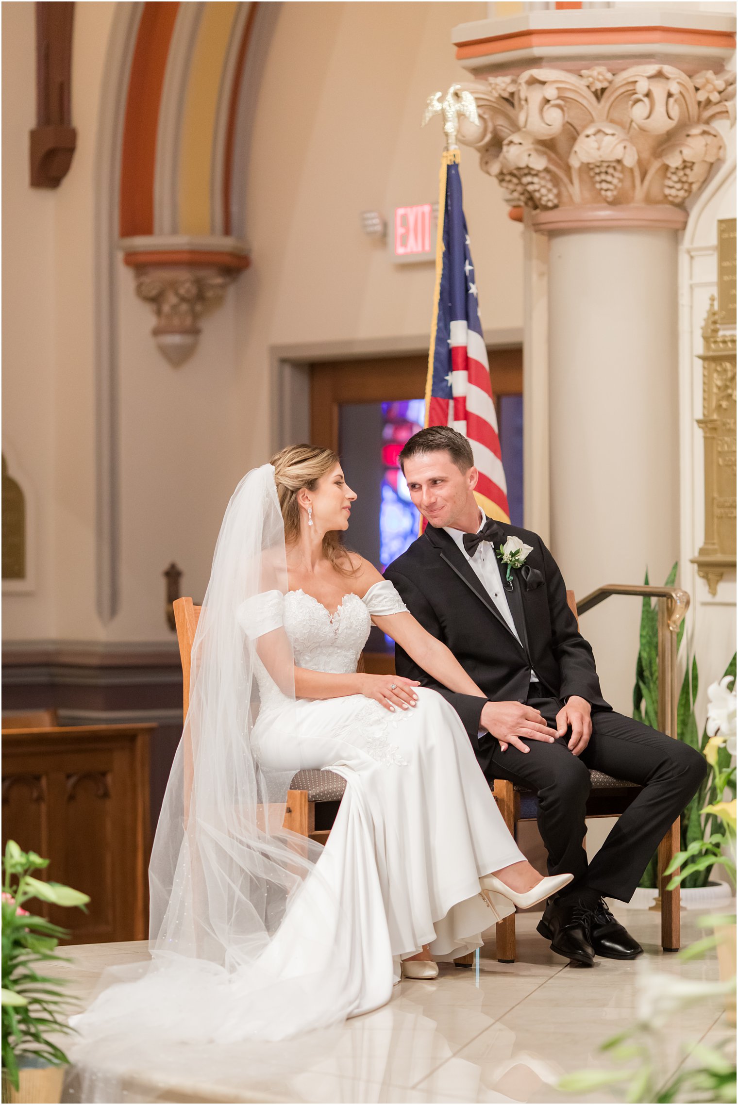 bride and groom look at each other during traditional Catholic Church wedding in New Jersey