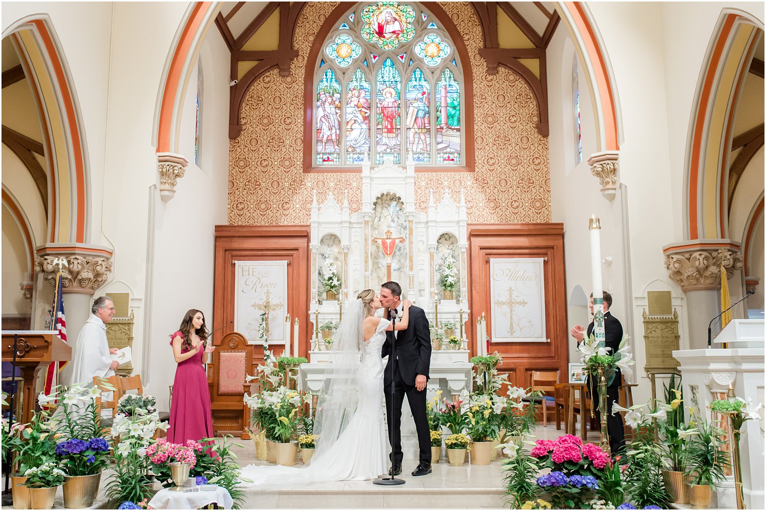 newlyweds kiss during traditional Catholic Church wedding in New Jersey