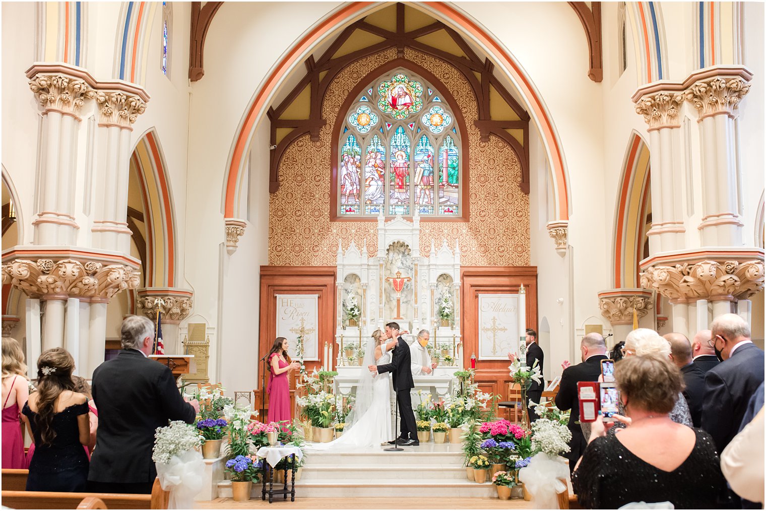 newlyweds kiss during traditional Catholic Church wedding in New Jersey