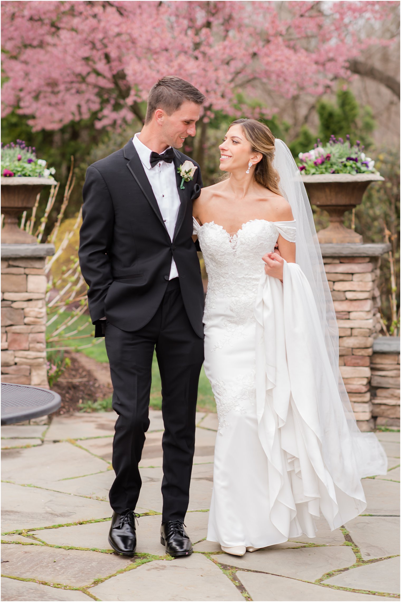 bride carries train while walking with groom at Park Savoy Estate