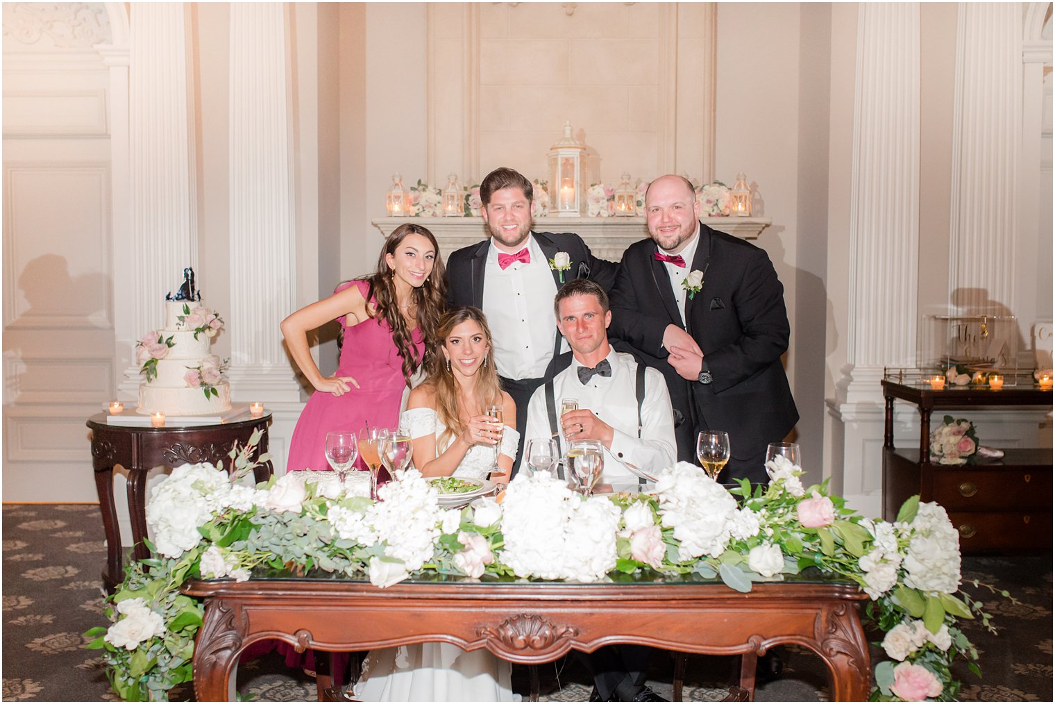 bride and groom pose with bridal party at NJ wedding reception 