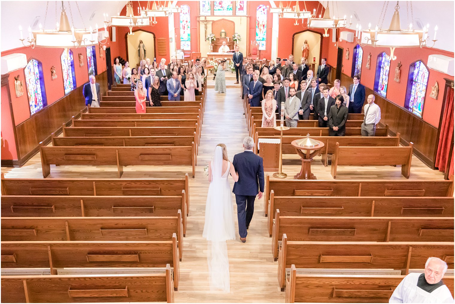 bride walks down aisle during church wedding in New Jersey 