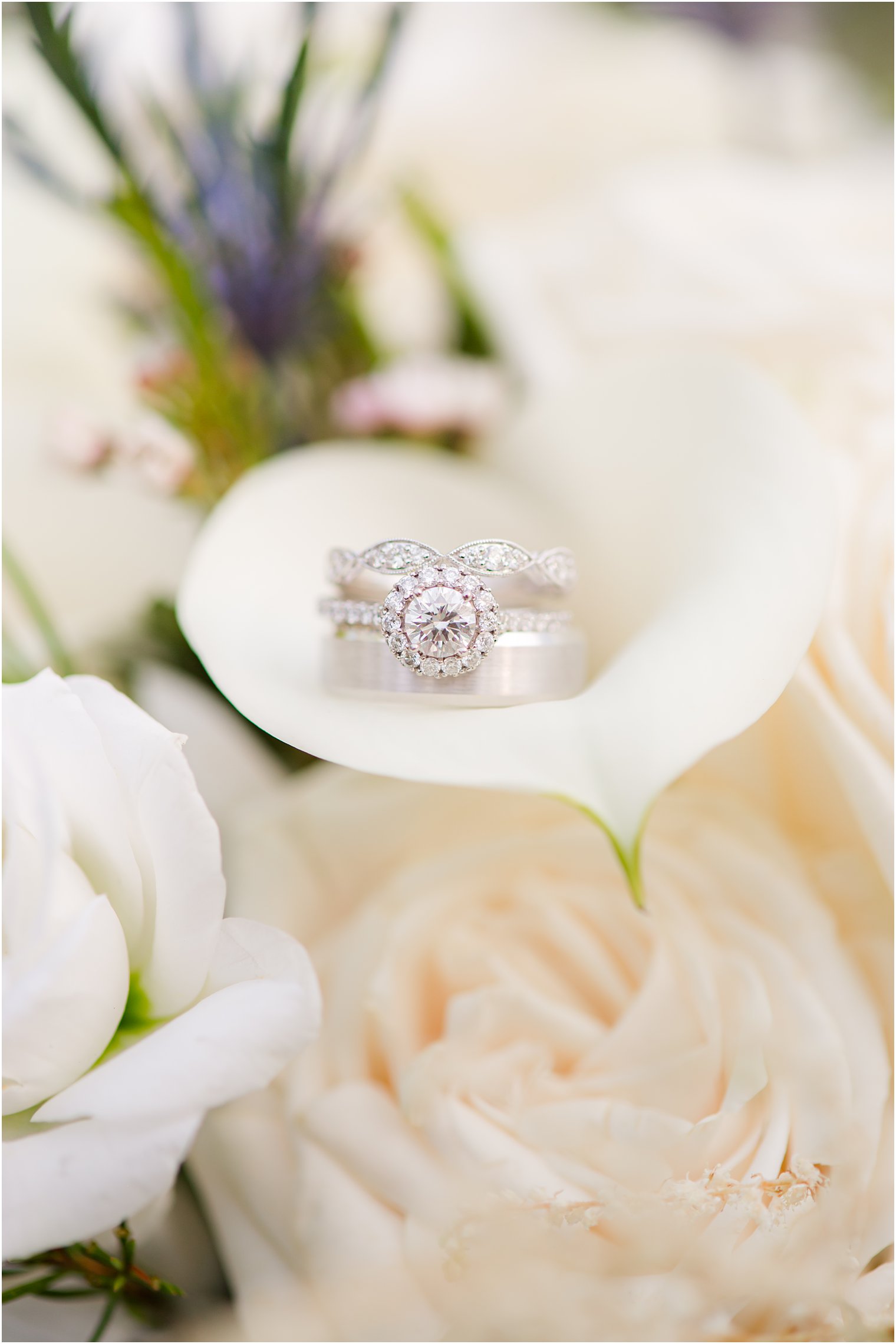 wedding rings rest on calla lily 