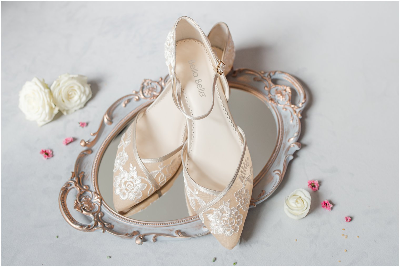 elegant ivory Bella Belle shoes for the bride sit on mirror 