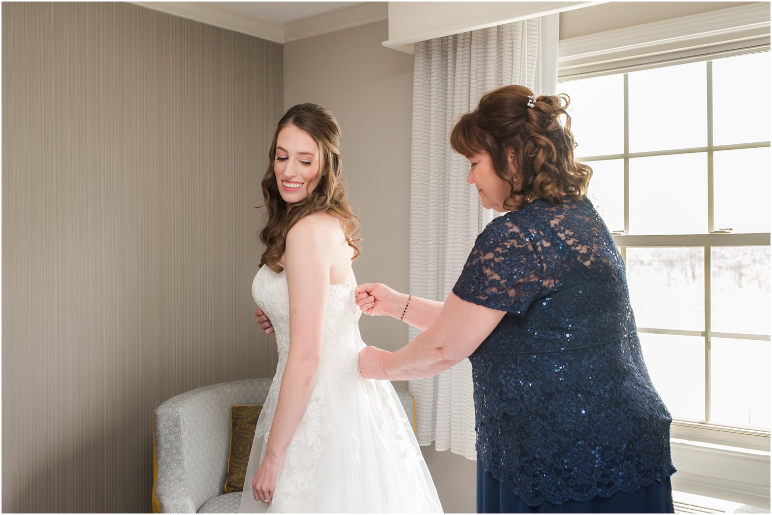 mother of the bride zips up wedding gown in New Jersey 