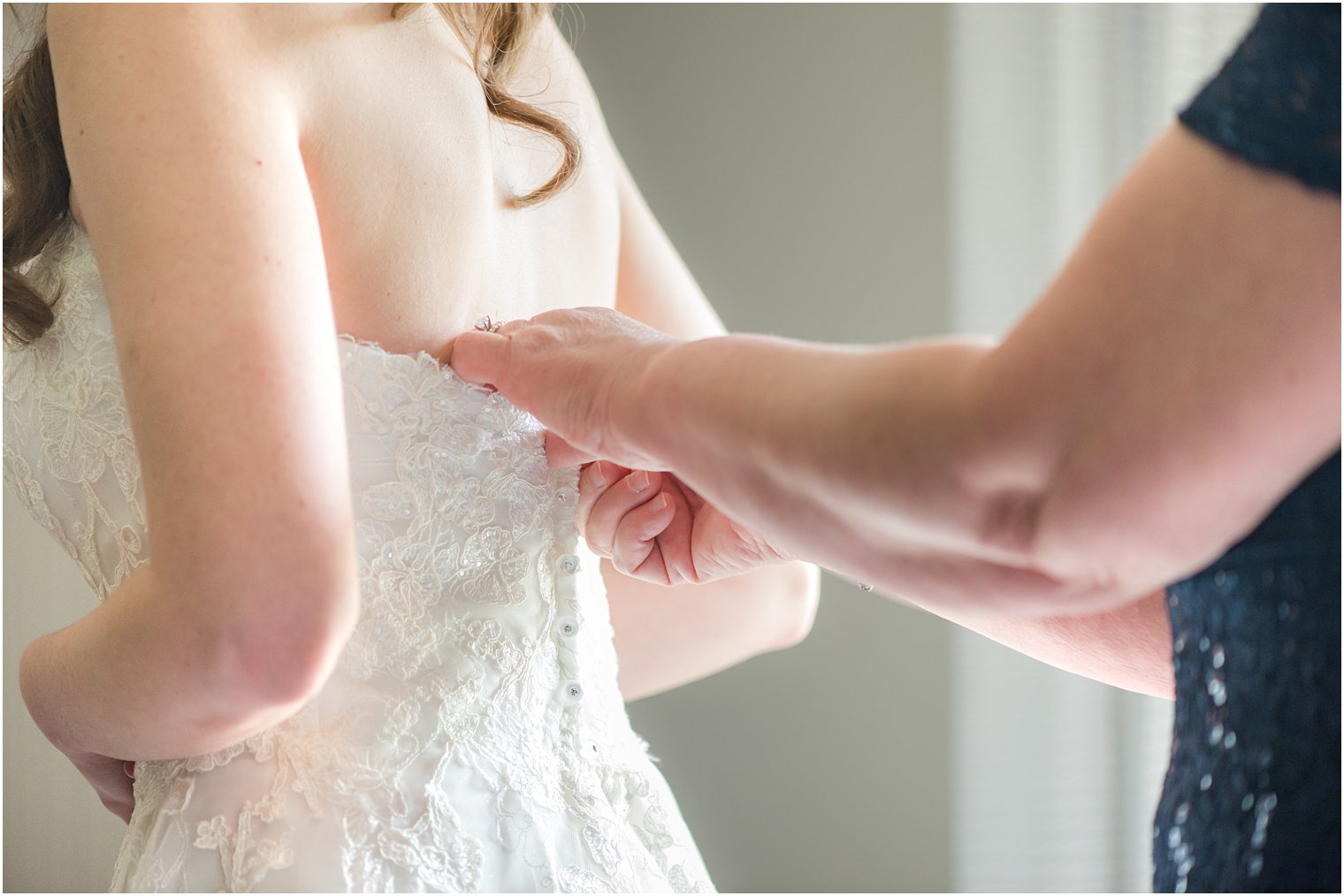 mother helps daughter with wedding dress on NJ wedding day