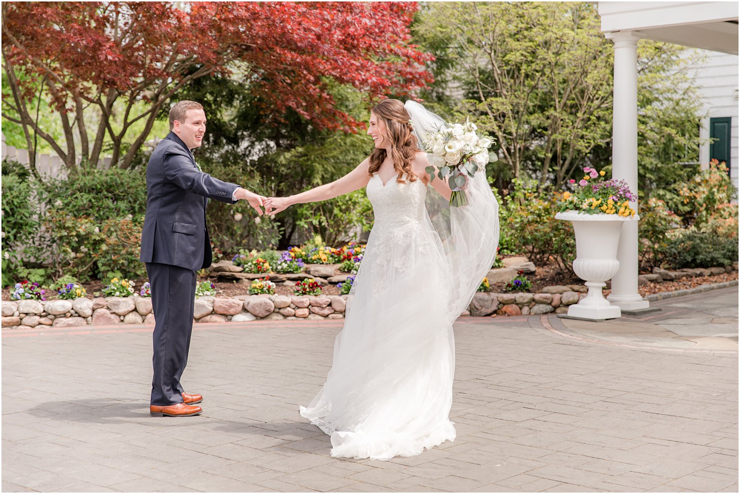 groom twirls bride during first look outside The English Manor 