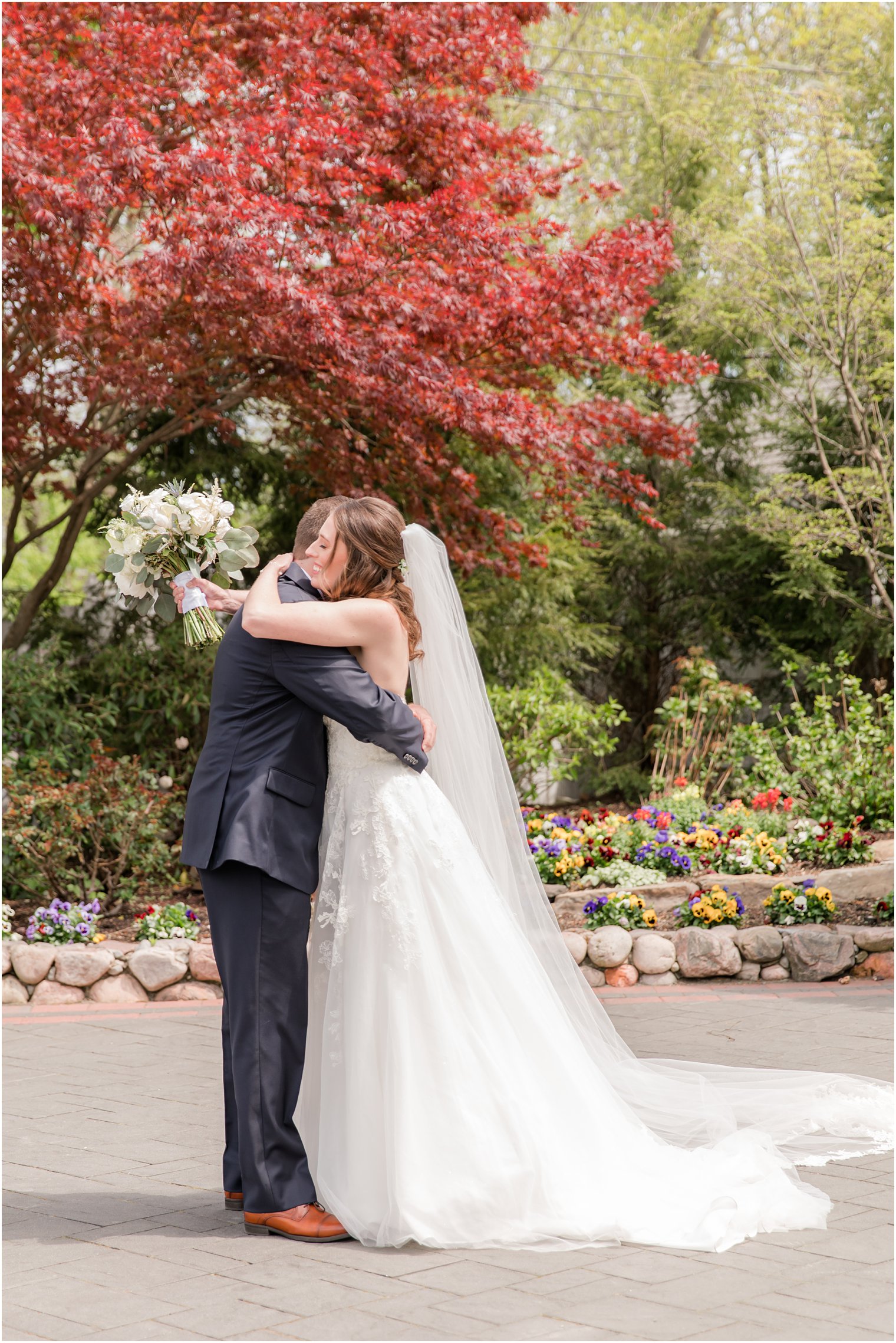 New Jersey newlyweds hug during first look before spring English Manor wedding day