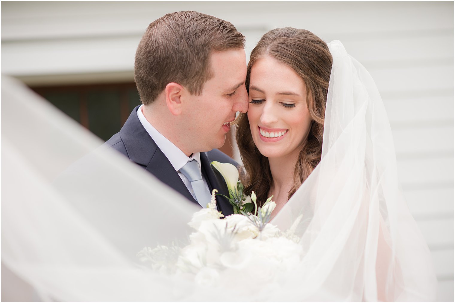 groom nuzzles bride's cheek during NJ wedding photos 