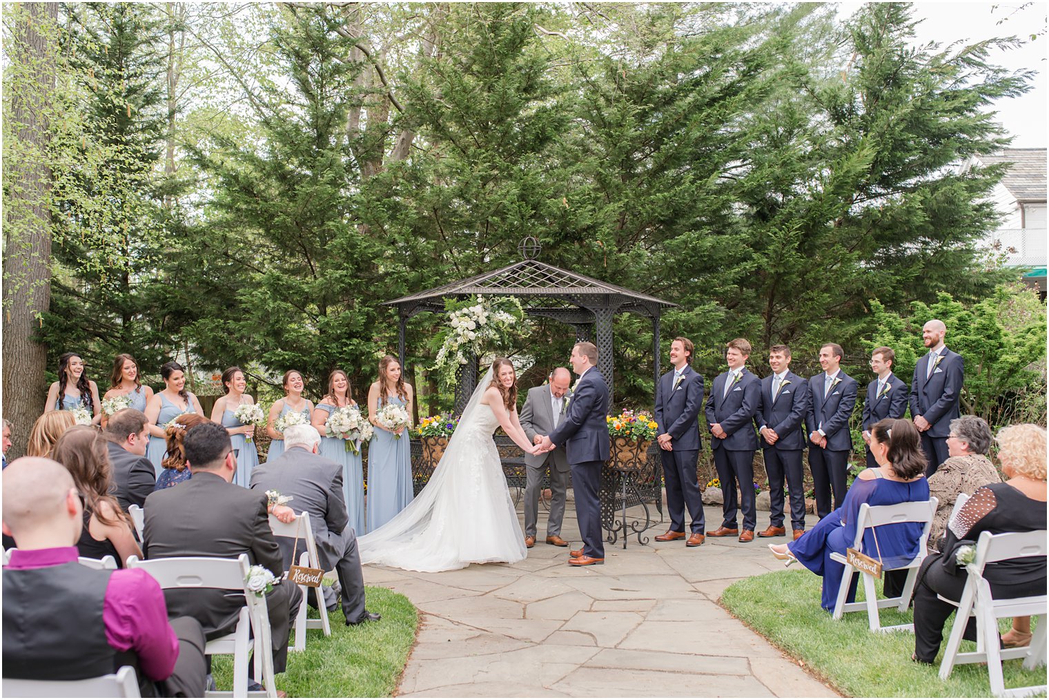 bride and groom laugh together during spring English Manor wedding ceremony 
