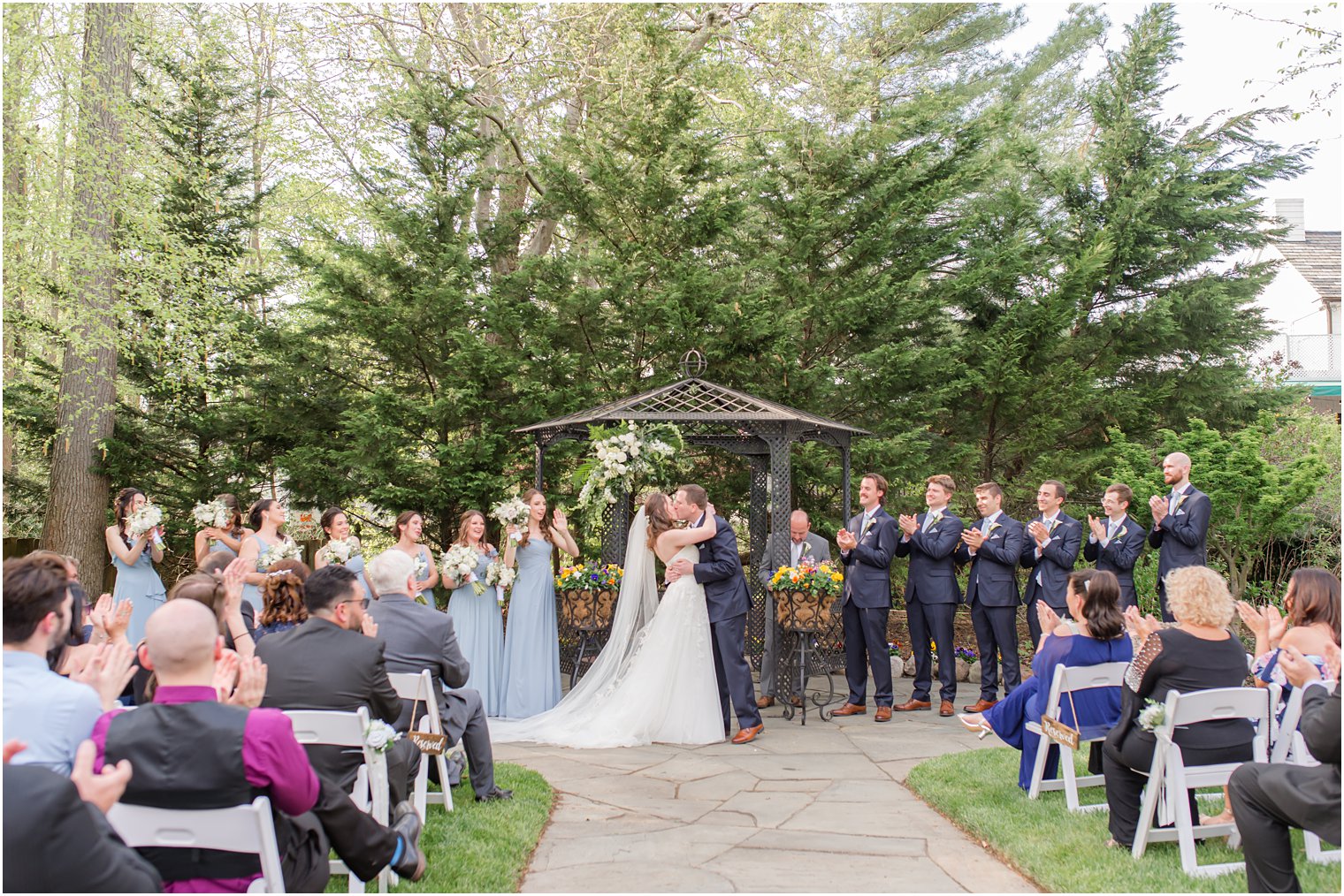 bride and groom kiss by black gazebo at The English Manor 