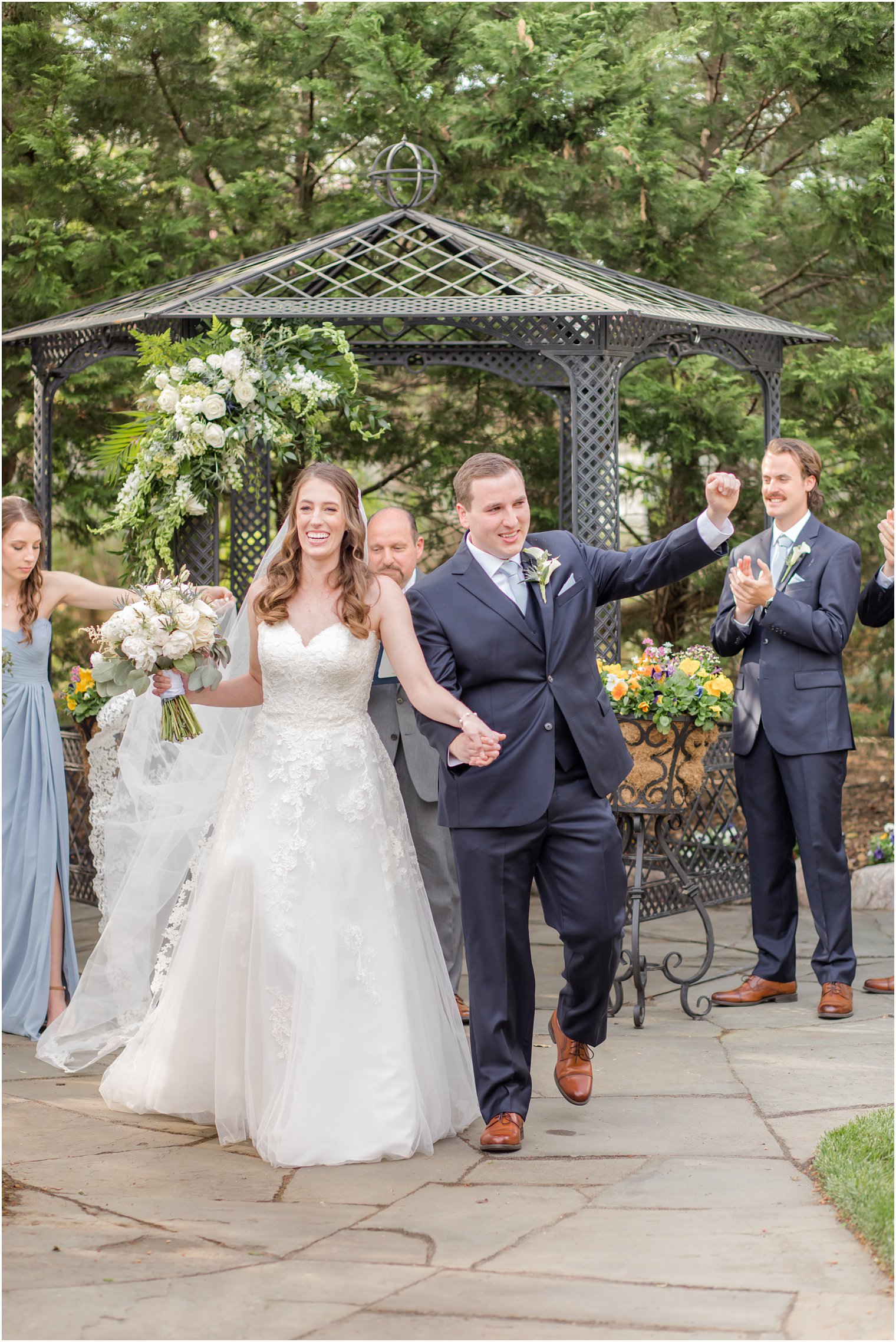 newlyweds walk up aisle after spring English Manor wedding ceremony 