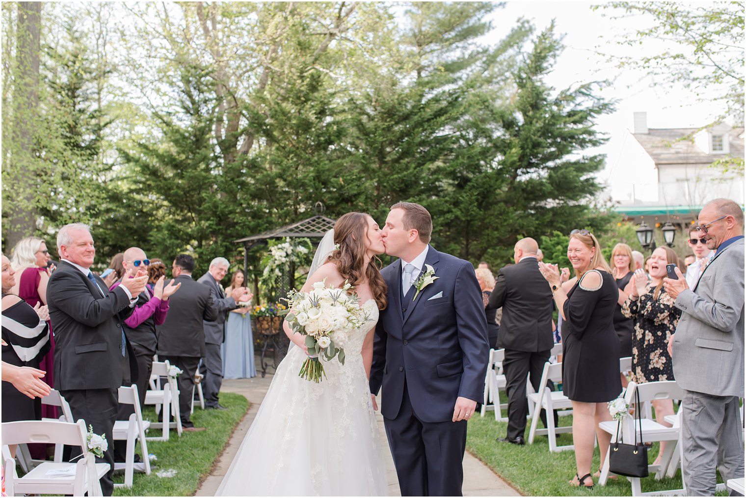 newlyweds kiss walking down aisle in Ocean NJ