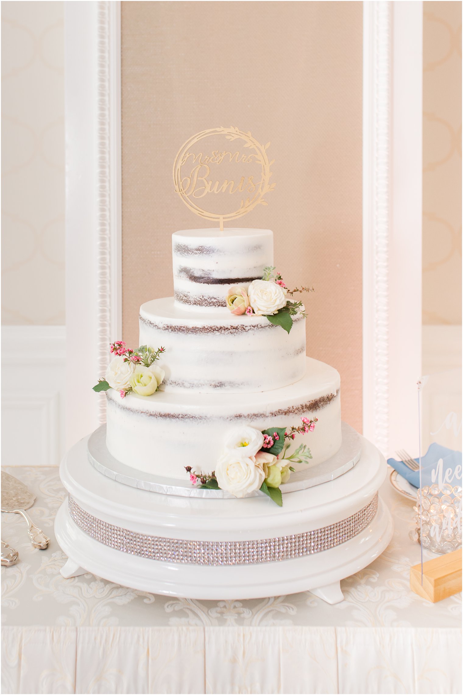 tiered naked wedding cake with gold topper 