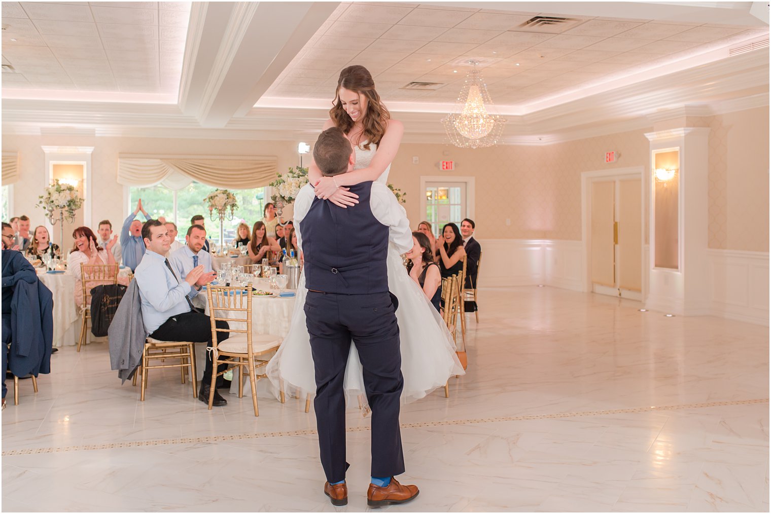 groom lifts bride during first dance in New Jersey 