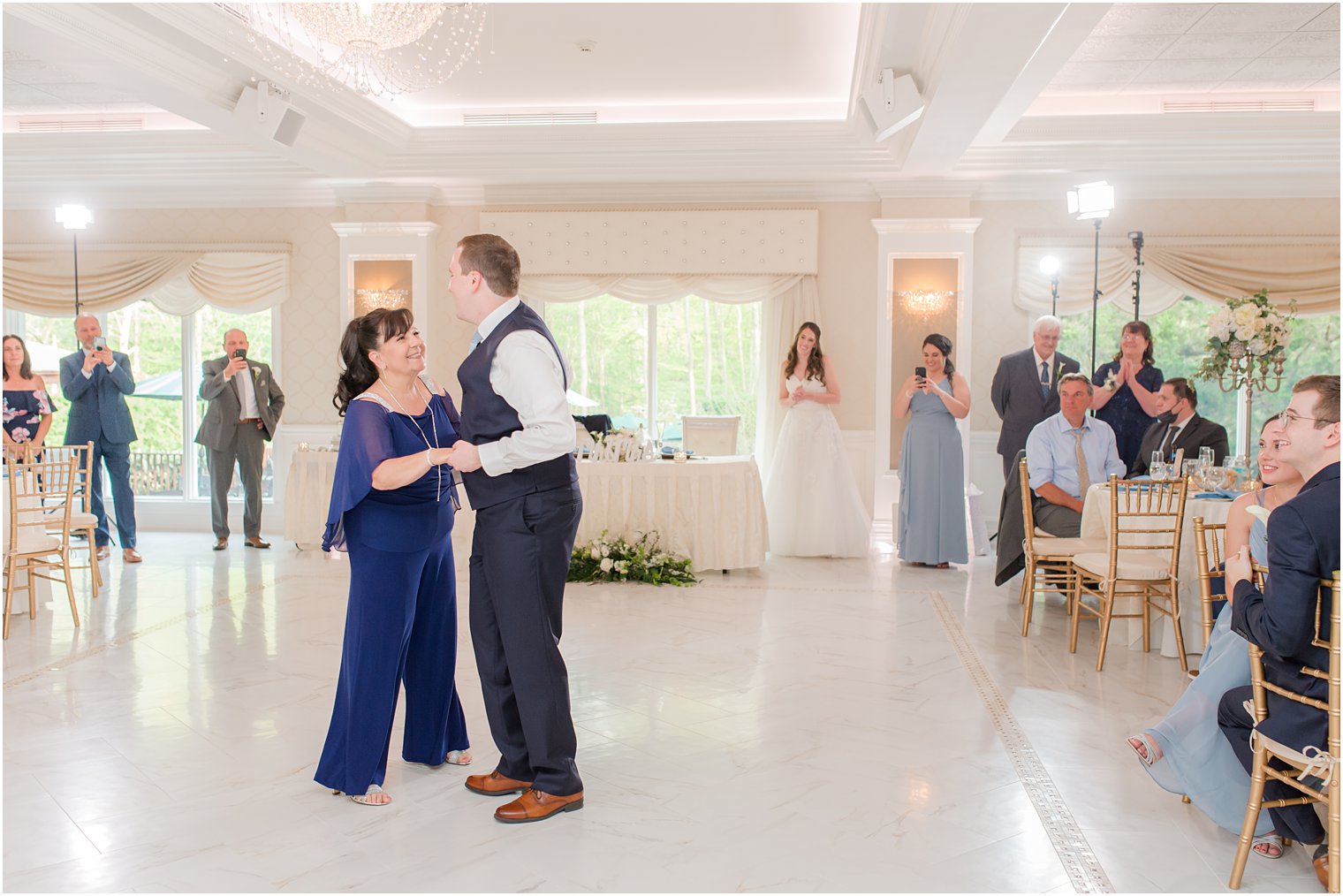 groom and mother dance during spring English Manor wedding reception 
