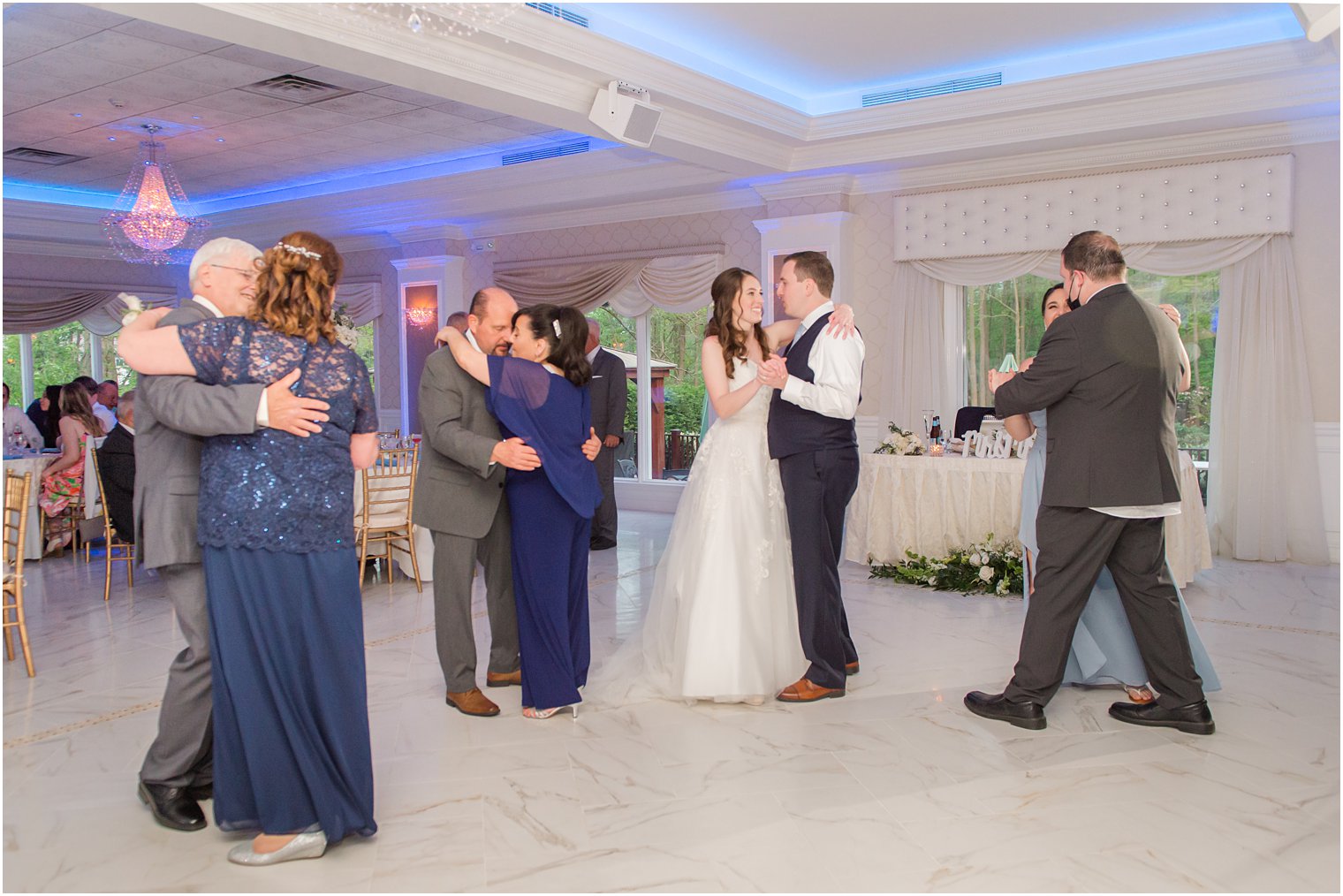 bride and groom dance with parents and family during NJ wedding reception 