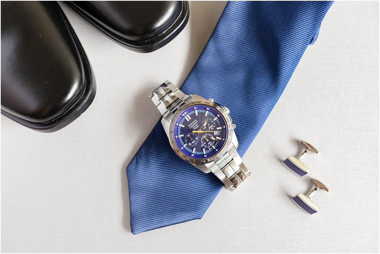 groom's watch rests on blue tie before NJ wedding 