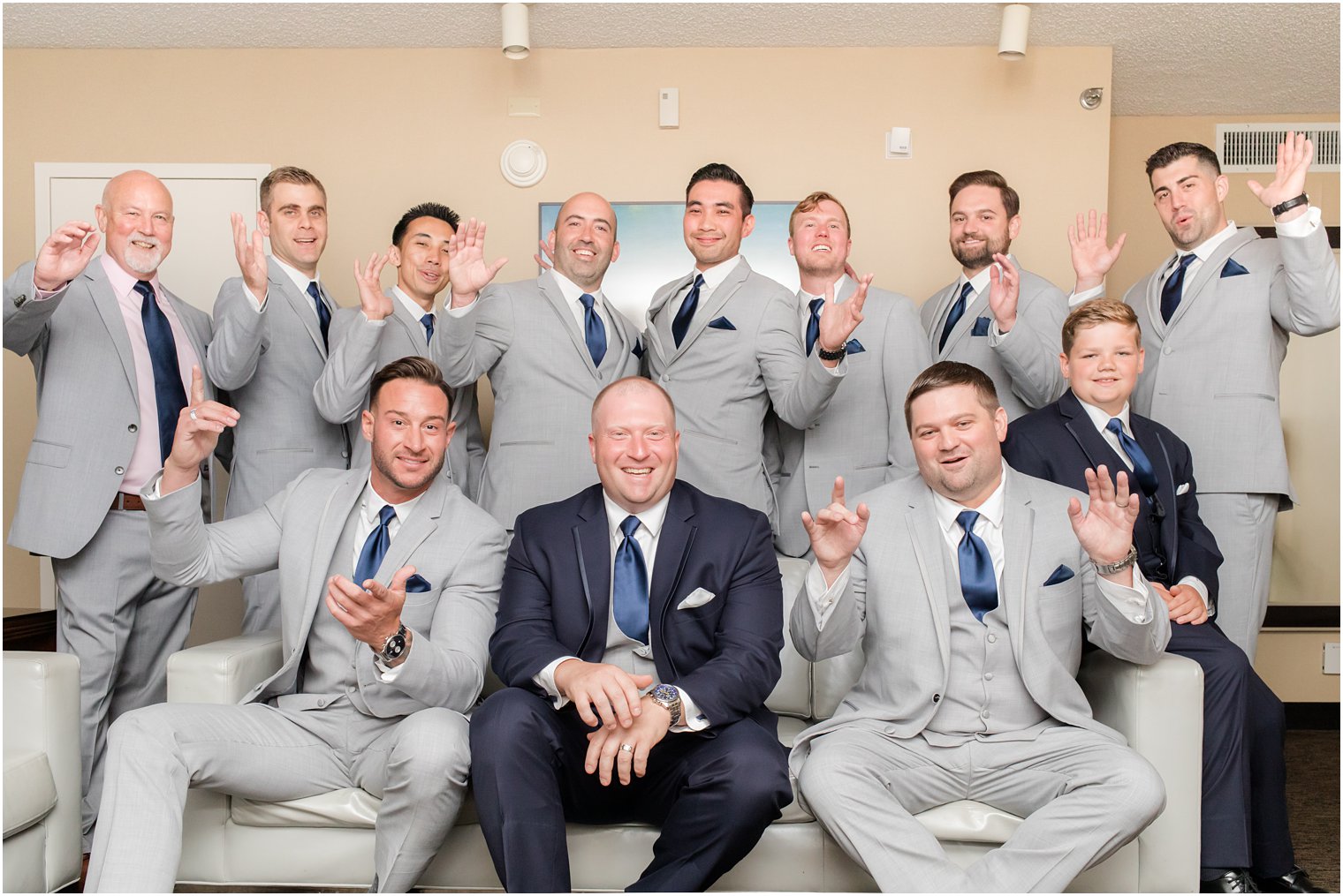 groom laughs with groomsmen during wedding day prep in NJ