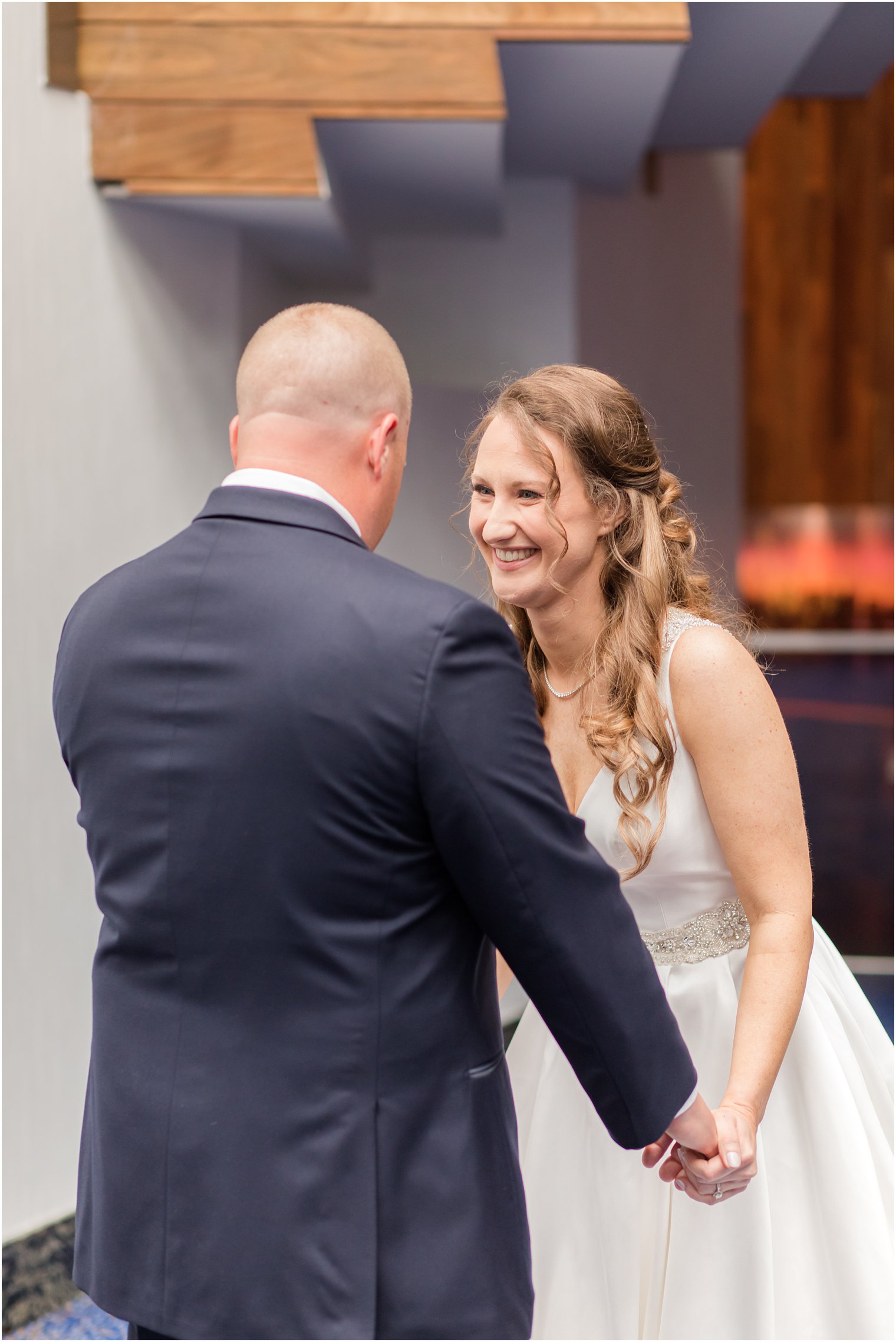 bride and groom laugh together during first look