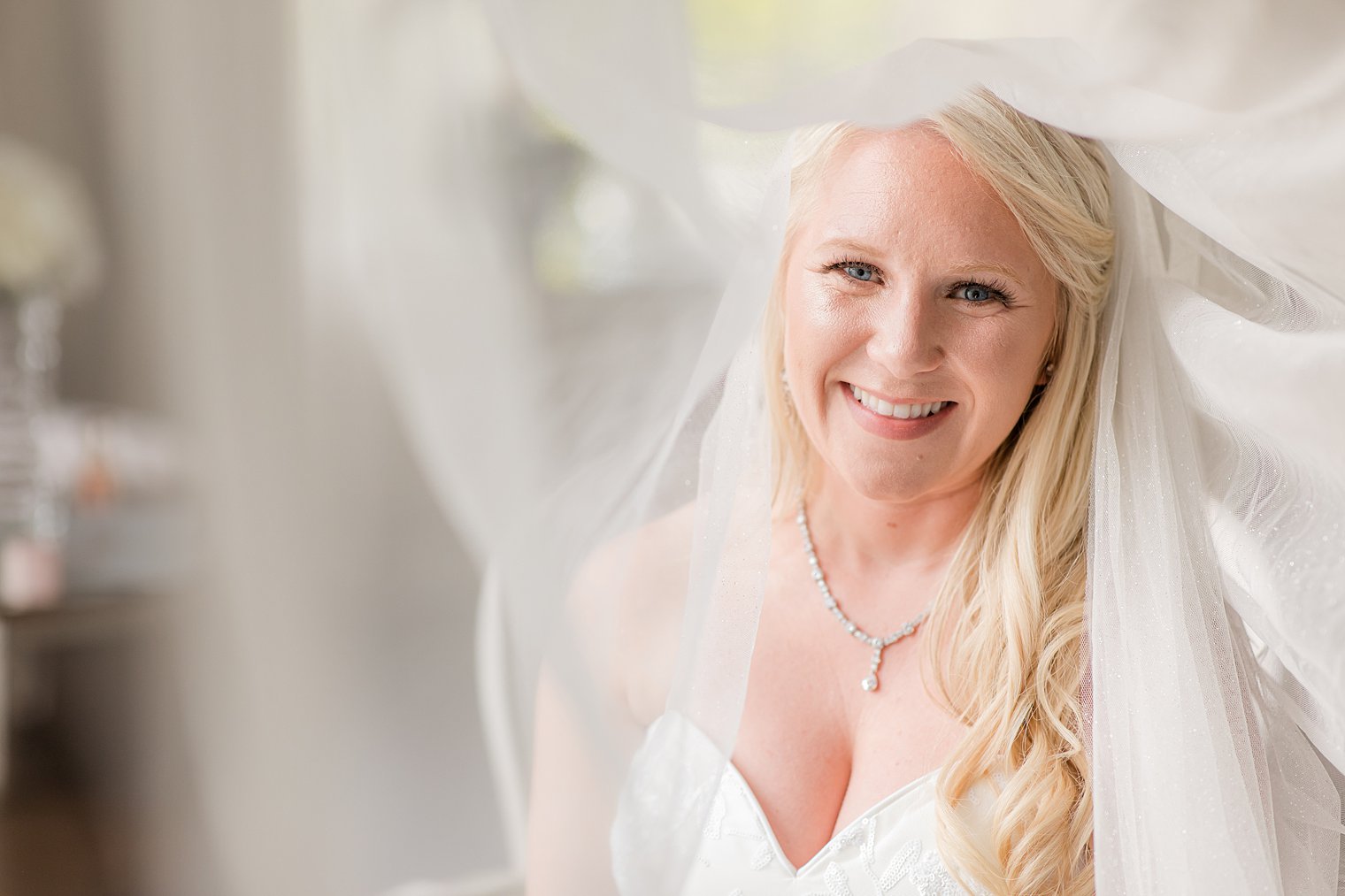 bride smiles under veil at Park Chateau Estate