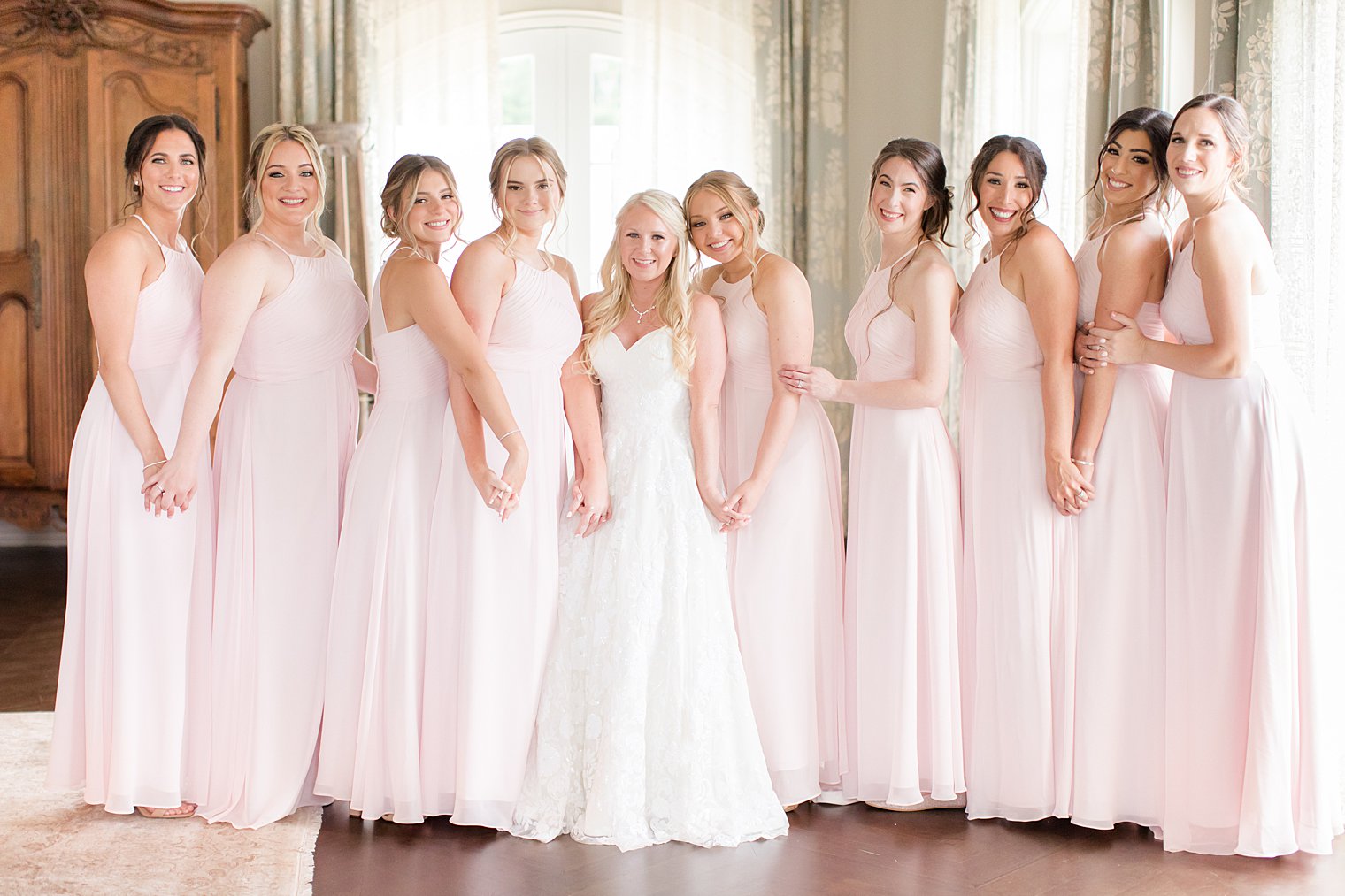 bride stands with bridesmaids in pale pink gowns at Park Chateau Estate