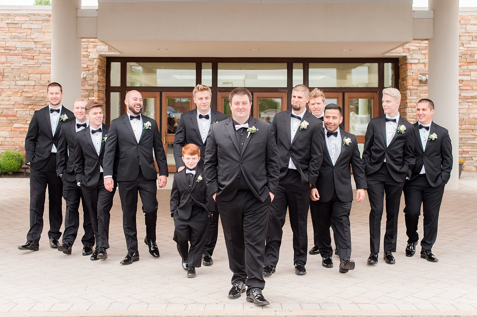 groom walks with groomsmen in New Jersey