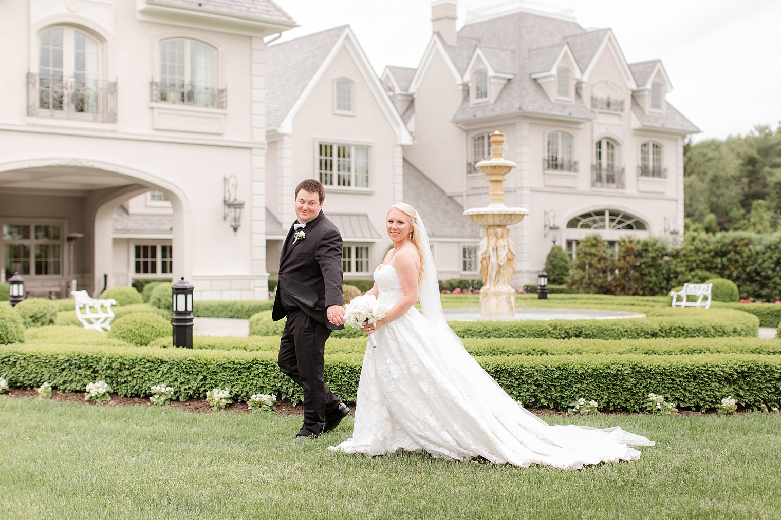 bride and groom hold hands walking through garden in New Brunswick NJ