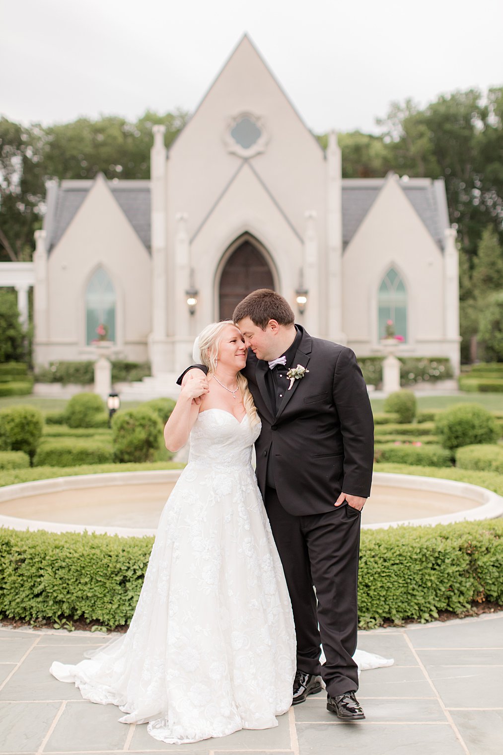 bride and groom look at each other outside Park Chateau Estate chapel