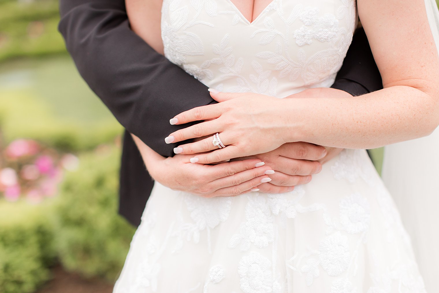 bride and groom hug with bride holding groom's arm