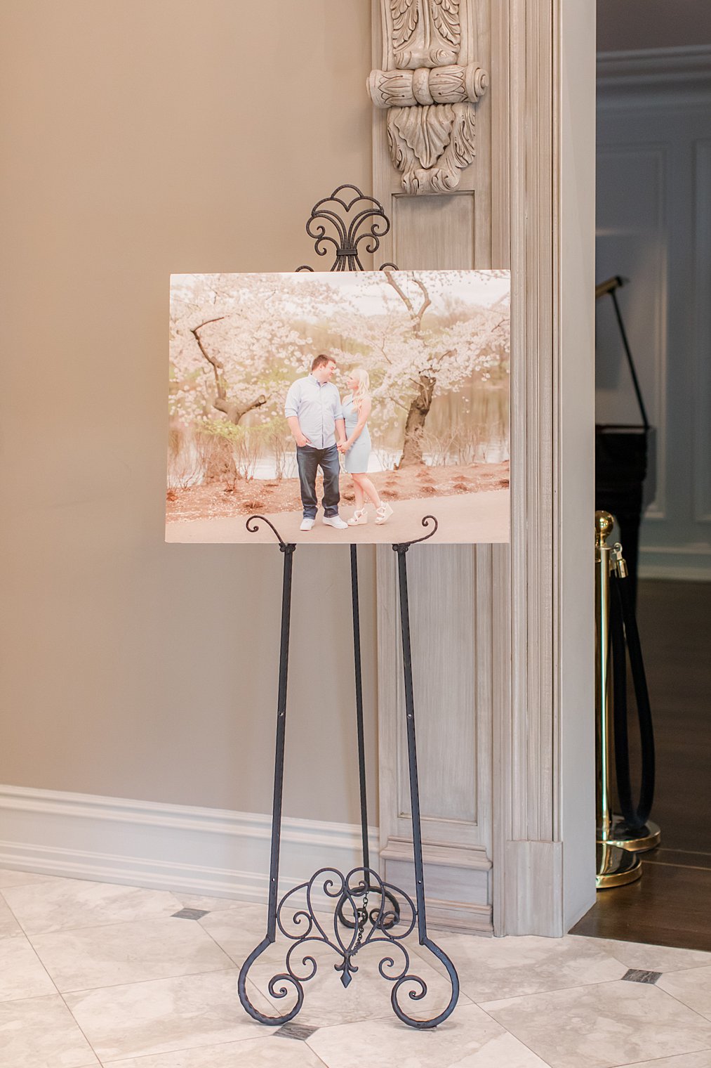 engagement photo of newlyweds stands by door 