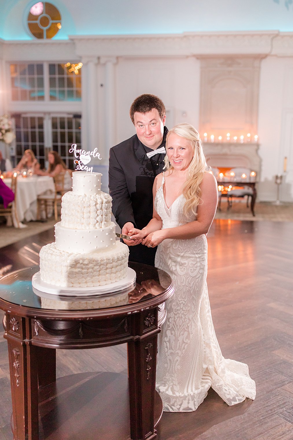 newlyweds cut wedding cake in New Jersey ballroom