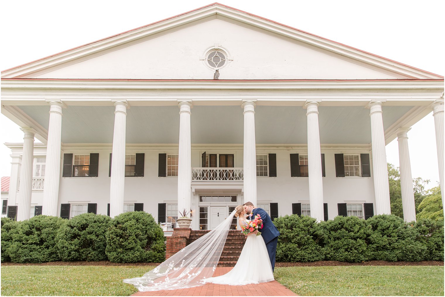 groom kisses bride outside Rosemont Manor in Berryville VA 