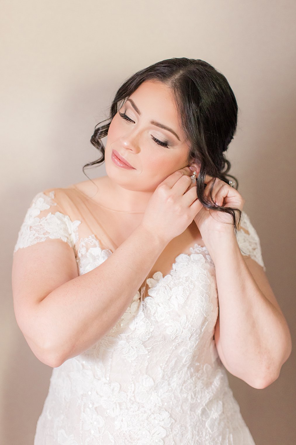 bride adjusts earrings for New York wedding day