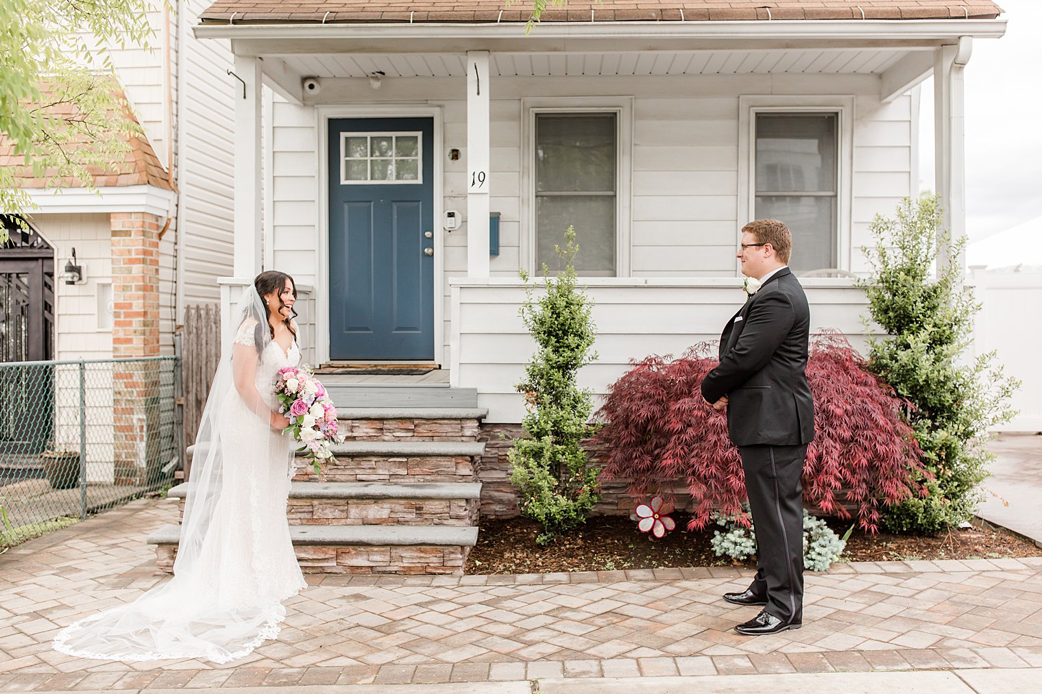 bride and groom have first look before Staten Island microwedding at home 