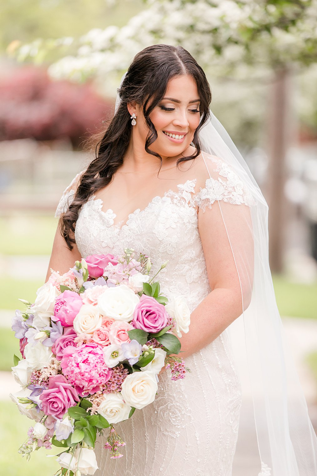 spring bridal portrait with bride holding bouquet of pink and ivory flowers 