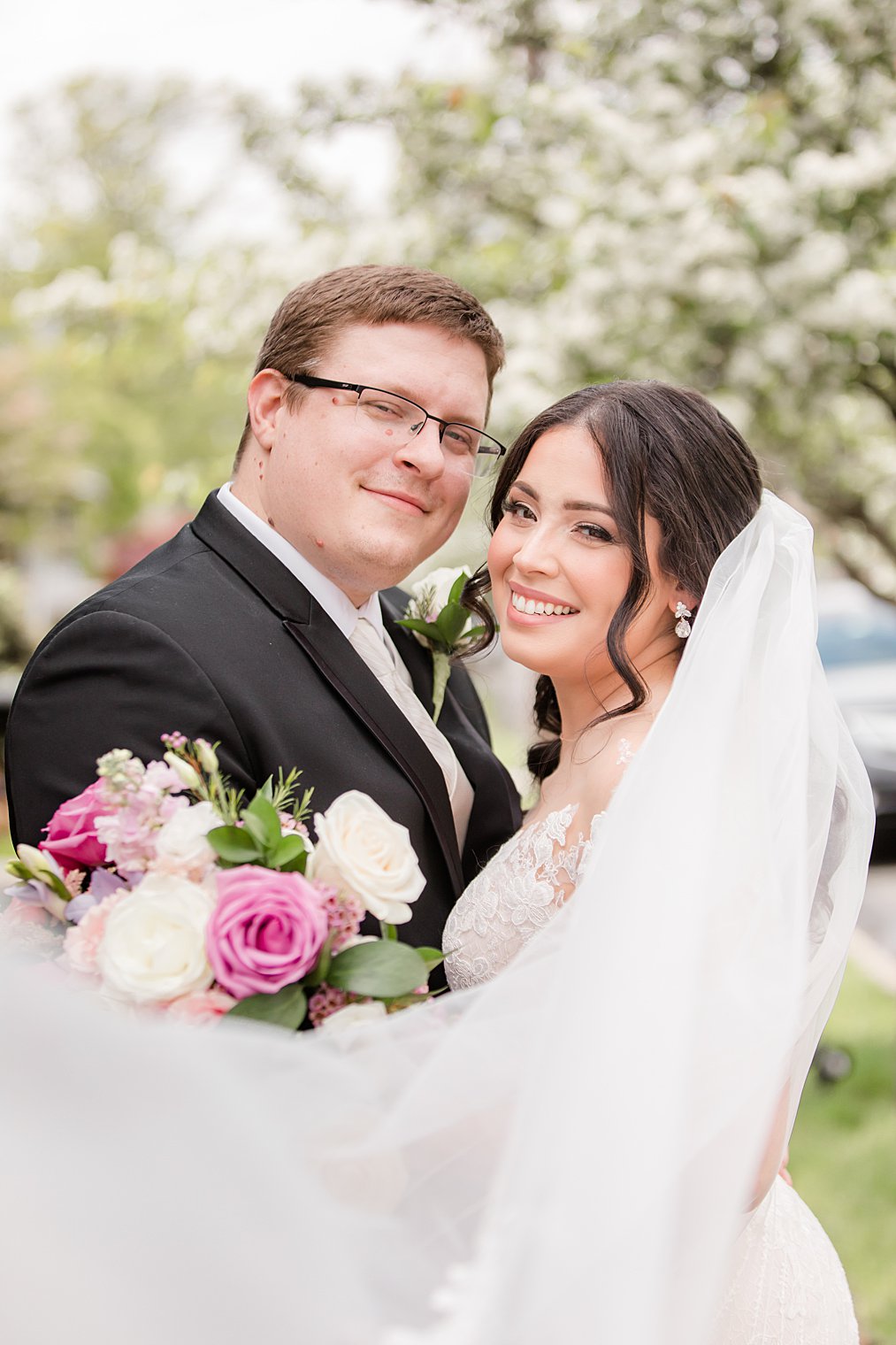 Staten Island wedding portraits of bride and groom with veil draped around them 