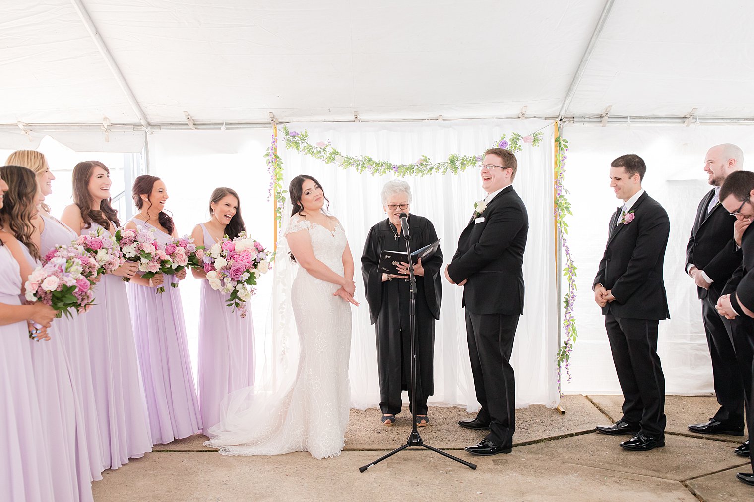 newlyweds laugh during backyard wedding ceremony 
