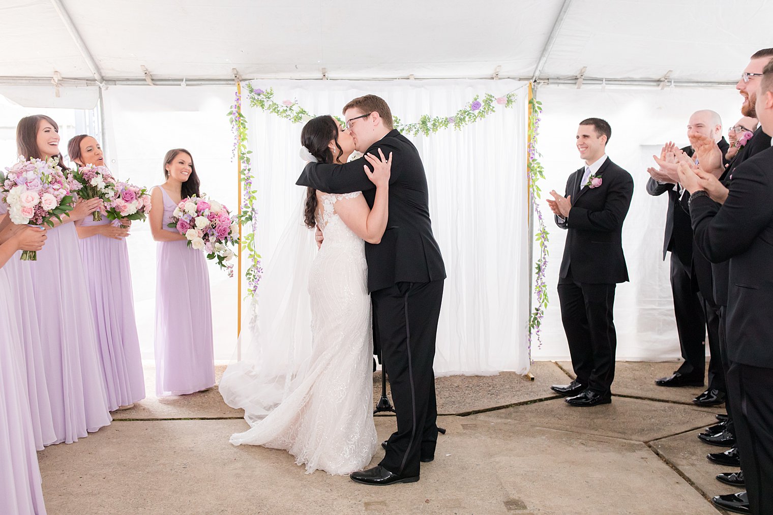 newlyweds kiss during Staten Island wedding in their backyard 