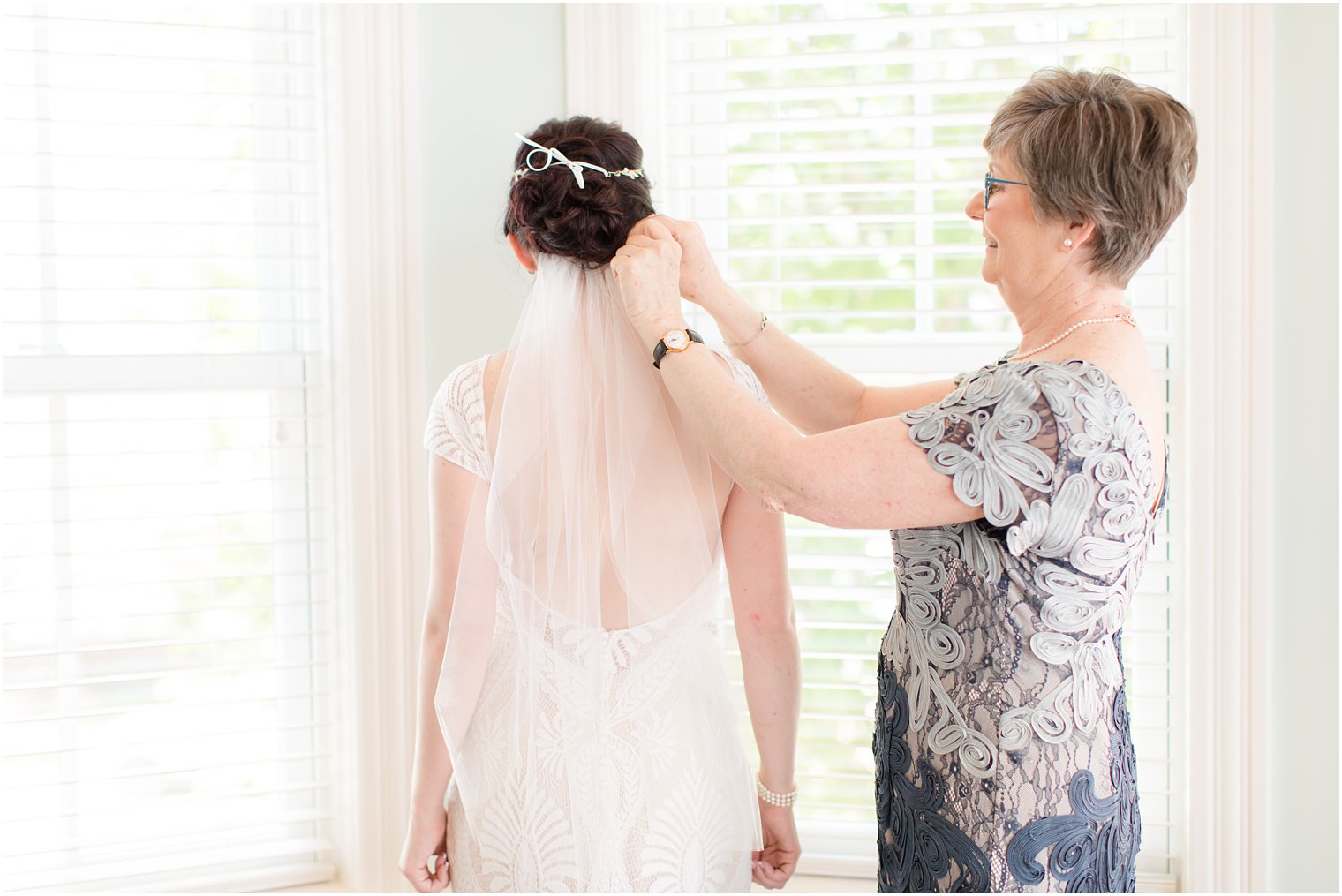 mother adjusts veil for bride before NJ wedding